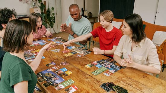 Amazon Prime Day board game deals - Amazon sales image showigng a happy group of people playing the 7 Wonders board game at a table
