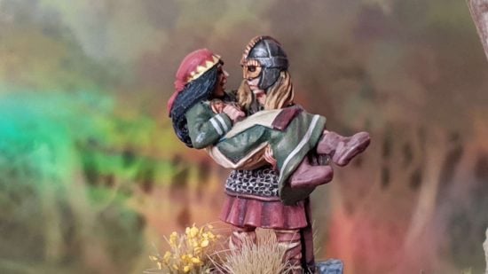 Female minis by Bad Squiddo Games - my heroine, a shieldmaiden holding a woman in both arms