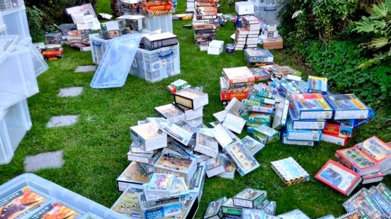 Part of a massive collection of sealed, OOP Warhammer boxed sets, in a garden