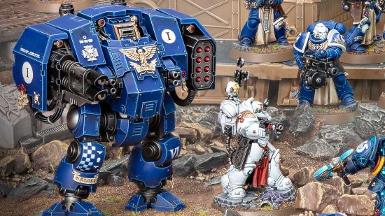 Warhammer 40k 10th edition core rules - product photo by Games Workshop of a heavily armoured walking warmachine called a Ballistus Dreadnought, beside a Space Marine apothecary