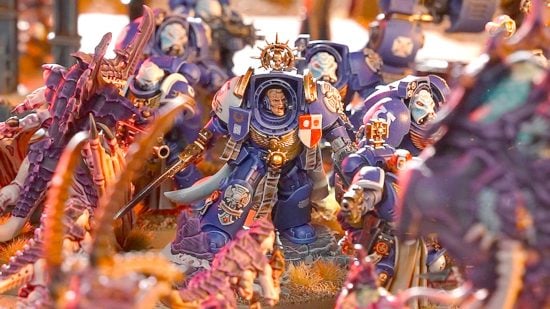 Warhammer 40k 10th Edition guide - GW Battle Report screenshot showing an Ultramarines Space Marine terminator captain and Terminators surrounded by Tyranids models