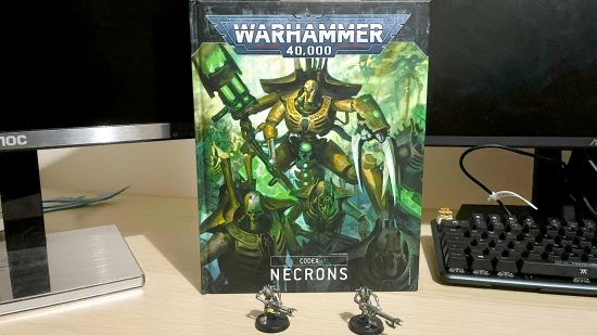 Warhammer 40k 10th edition painting minis with a tremor - author photo showing two Necron warrior models in sautekh colors, and the 9th Edition Necrons codex book