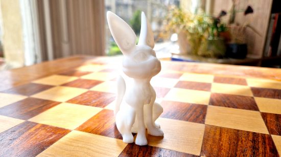 How to 3D print miniatures guide - author photo showing a rabbit cat model printed using the Ankermake M5 FDM printer