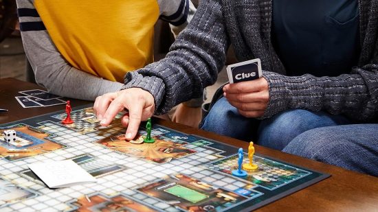 How to play Cluedo - two players interacting with a Cluedo board
