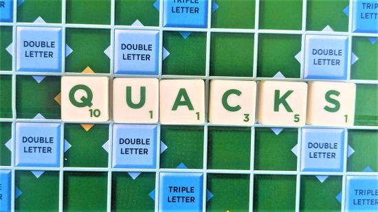 Scrabble words with Q - photo of the word Quacks on a Scrabble board