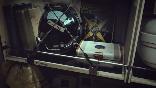 Could there be a Starfield board game? - promo shot by Bethesda of a starfarer's shelf, with a damaged helmet sitting beside books and a white box