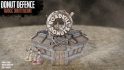 Warhammer 40k terrain from the Donut Defence Kickstarter - front view of a heavily reinforced donut shop. An ornamental donut says "Roadkill donuts"