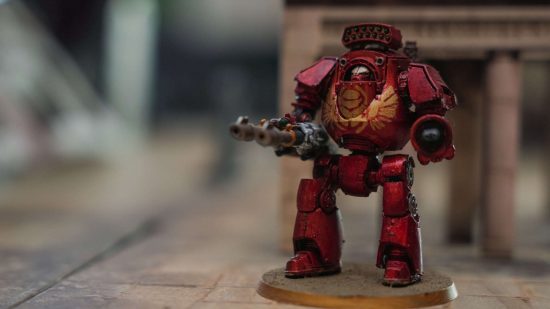 Warhammer MMO lead developer Jack Emmert's model collection - a red Thousand Sons contemptor dreadnought with a golden scarab logo