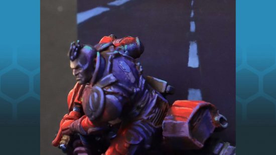 A Warhammer 40k Genestealer Cult Atalan Jackal converted to look like Kaneda from Akira by Paul Michel - rear side view of a model of a biker on a red motorbike, with blue-toned shadows