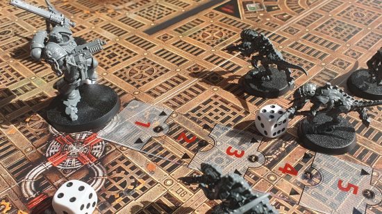 Warhammer 40k Space Marine the Board Game - ma measuring stick is used to check the distance between the Space Marine Lt. Titus and the alien Tyranids