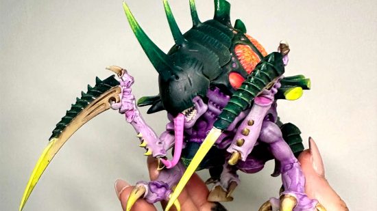 The online Warhammer community rally for a 24 hour charity painting challenge on Miniature Frontier Twitch - a Tyranid Malanthrope, a huge beetle-like monster with massive claws and a huge, armored brain, painted by Kerry Lidell