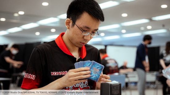 Professional picture of a Yu-Gi-Oh World Championship 2023 TCG player looking at their cards