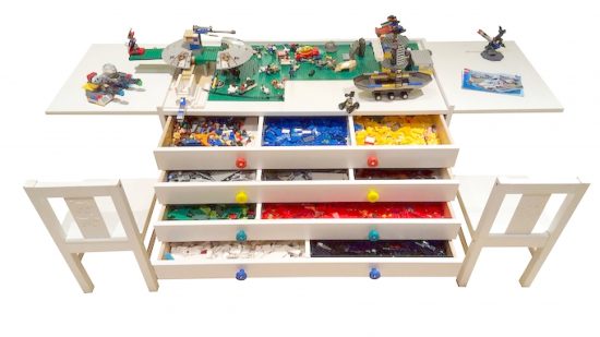 Best Lego tables guide - marketing photo showing thbe Brick Inovations BOSS executive table, with drawers full of different color Lego bricks and various Lego models on the top