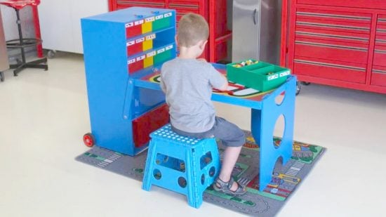 Best Lego tables guide - marketing photo showing the portable Lego Creation Station table, with a child sitting on a stool at the table, playing with some LEGO