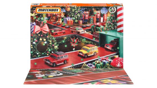 Best Matchbox cars, marketing photograph by Mattel - an advent calendar, decorated to show a 'road grid' of red ribbon along which diecast toy cars are travelling