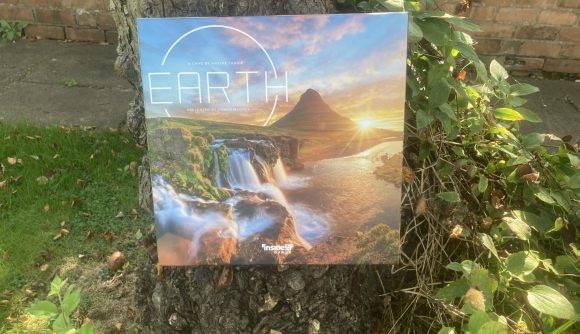 Earth board game placed on a tree.
