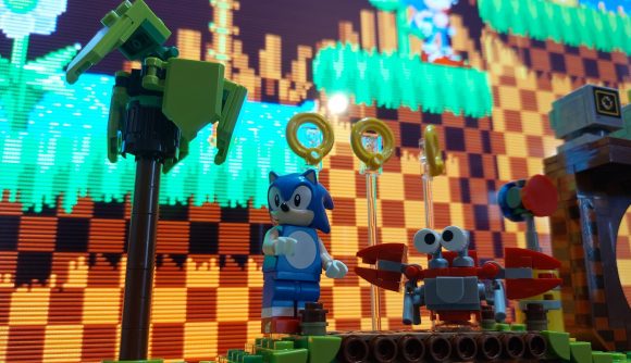 Lego Sonic the Hedgehog set in front of some of the classic game graphics.