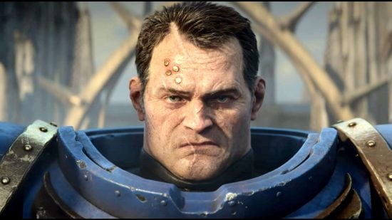 Screenshot from Space Marine 2 trailer, closeup of Lt. Titus without portrait, a glowering dark-haired man with many facial scars, extremely strong bones, and four metal studs on his right brow, wearing heavy blue and gold power armor
