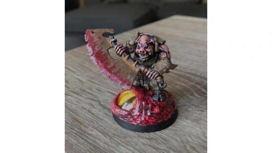 Warhammer Orruk brute converted into a Darkest Dungeon Swine - a pig-faced brute with vicious blades and bulky, rusted armor