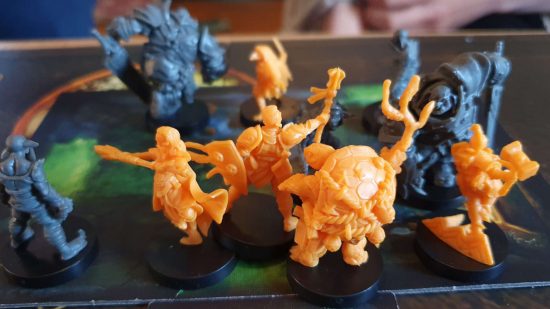 Bardsung review - plastic miniatures, yellow hero miniatures including a turtle sage and bird rogue fight against monsters