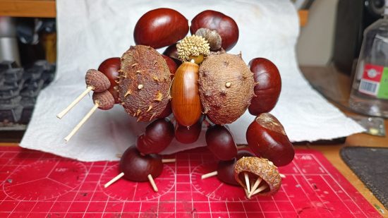 A Warhammer 40k Space Marine dreadnought converted out of conkers, acorns, and toothpicks, by Jacek Kołodziej