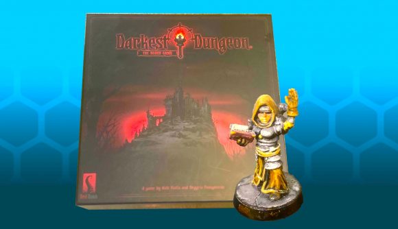 Darkest Dungeon board game box and mini