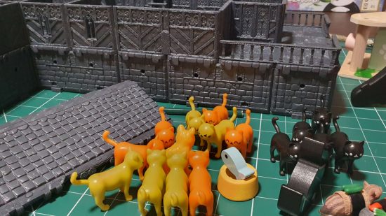 A gang of plastic cats gather in front of the Scales and Ales Tavern DnD Inn kit