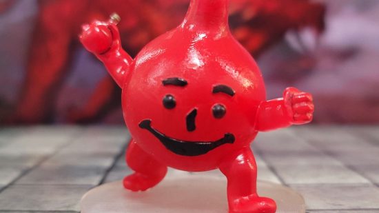 DnD miniature of the Kool Aid Man, a gurning red bottle leaping towards the viewer - the Healing Potion Golem designed by Miguel Zavala