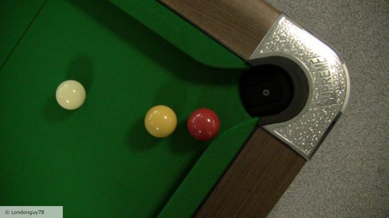 How to play pool - photo of three pool balls on a pool table