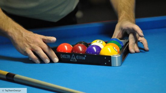 How to play pool - photo of a player arranging balls with a triangle rack on a pool table