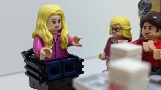 Lego Big Bang Theory review image showing Penny, Bernadette, and Howard sitting around a table.