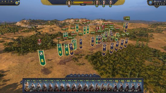 Total War Pharaoh review - game screenshot showing a real time battle with two large forces arrayed in a forested plain