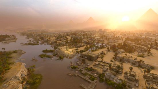 Total War Pharaoh review - game screenshot showing sunrise over the Nile, Pyramids, and a settlement
