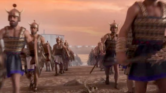 Total War Pharaoh review - Creative Assembly trailer screenshot showing hundreds of Sea Peoples warriors marching up a beach towards war
