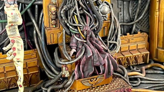 Closeup of Daniel McGirr's first Warhammer 40k Golden Throne Diorama - the Emperor, a skeletal figure in dark robes, connected by many wires to the mechanisms of a strange machine