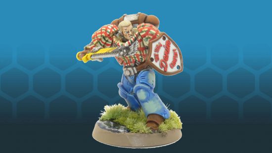 A Warhammer 40k Space Marine wielding a chainsword and shield, painted by Nick to look like he's wearing blue jeans, plaid shirt, and leather accessories