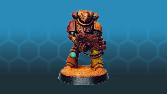 A re, yellow,and orange Space Marine, painted by Morose.Miniatures and his six year old daughter