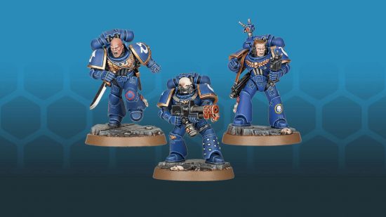 Three blue-armored Warhammer 40k Space Marines, one with a flamer, one with an auspex, one running with a combat knife