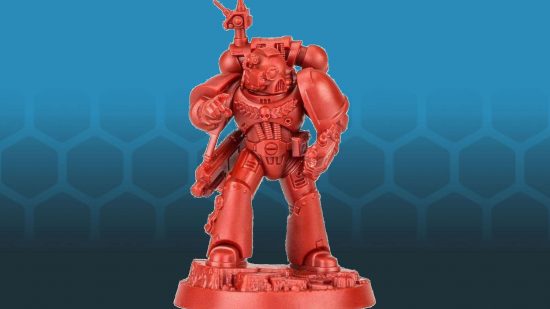 An unpainted Warhammer 40k Space Marine figure made of red plastic- an armored warrior consulting an auspex