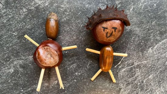 Two simple dolls made from cocktail sticks, conkers, acorns, and pieces of shell, by Morose Miniatures' daughter