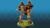 A Warlord-class Warhammer Titan made from conkers,a corns, chestnuts, and pieces of shell, on a moss-covered base