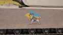 World of Tanks creator raises funds for ambulances for Ukraine - a decal of a small dog in shades and combat vest, against the Ukrainian flag, painted onto the side skirts of a tank