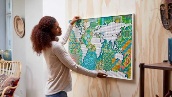 Hardest Lego Sets - A woman mounts the Lego Art World Map on the wall