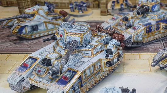 Legions Imperialis review - Solar Auxilia super heavy tanks advance through a city