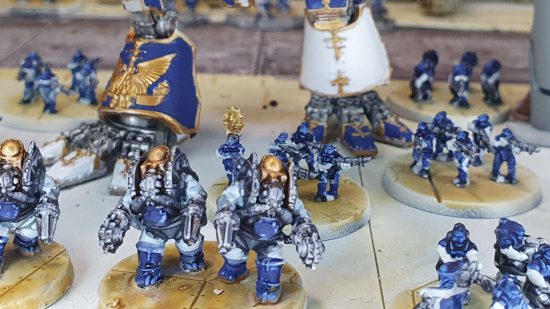 Legions Imperialis review - tiny Solar Auxilia infantry beneath the feat of a Warhound Titan