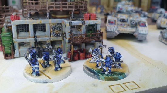Legions Imperialis review - two stands of tiny Solar Auxilia Veletarii in the lee of a building