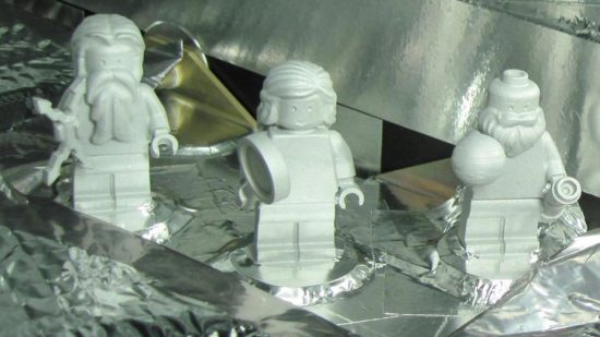 Rare :Lgo pieces - three lego minifigures attached to a space exploration vessel
