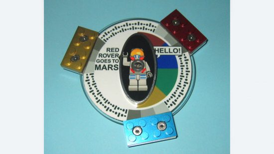 Rare lego pieces - a "Red rover Goes to Mars" DVD held in place on a Mars explorer lander with three solid metal Lego bricks