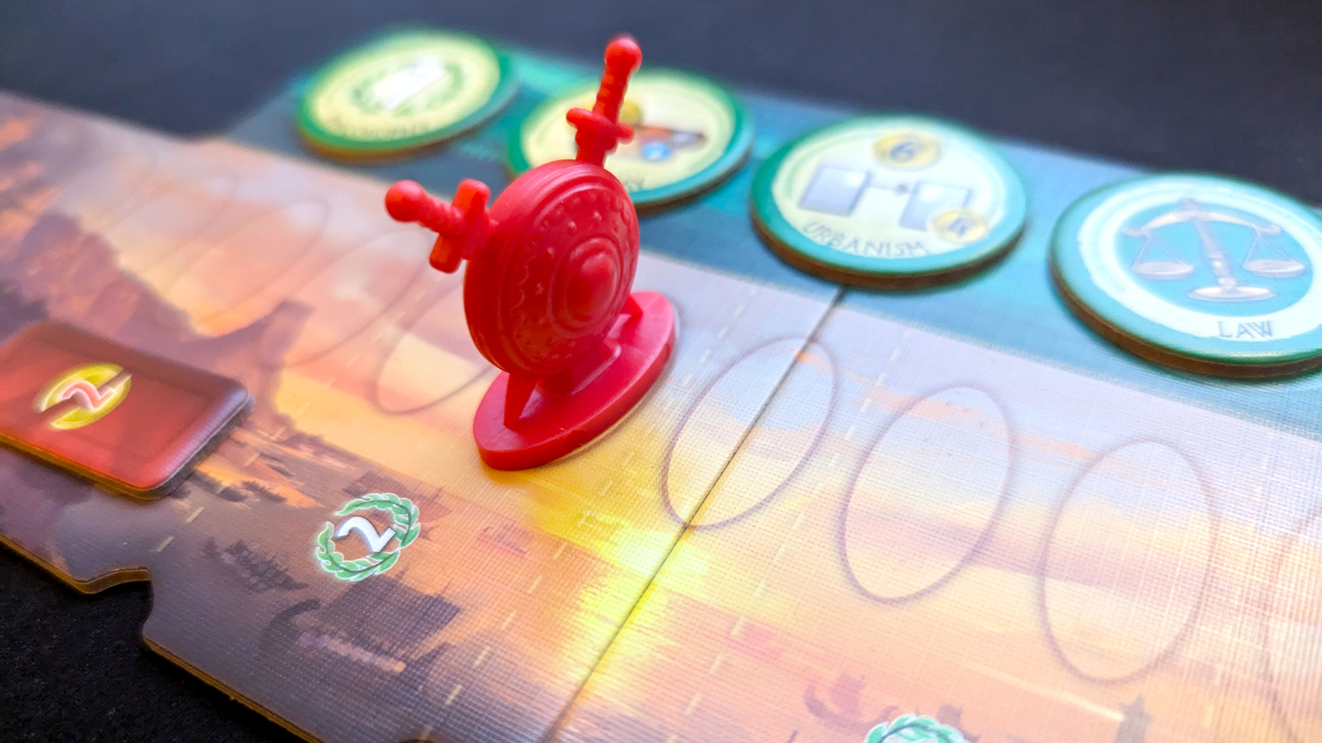 7 Wonders Duel review - author photo showing the game's military victory track with tokens and the red marker pawn