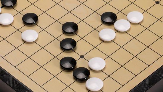 How to play Go rules - photo of black and white Go stones